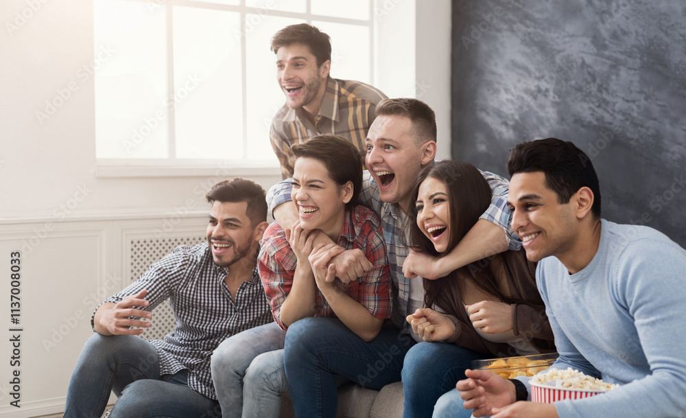 Happy friends with popcorn watch film on the sofa at home Happy friends with popcorn watch film on the sofa at home