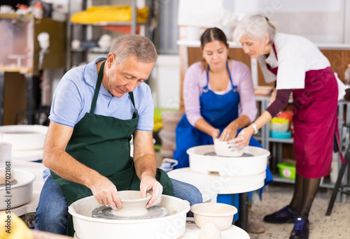 important part of potter's work is molding product on potter's wheel photo