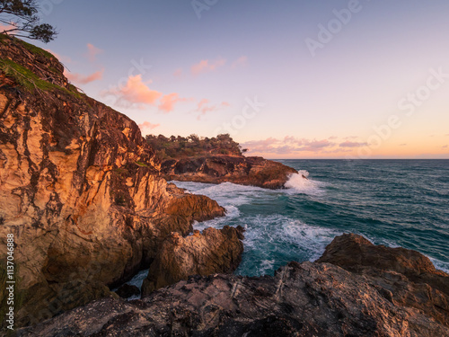 Waves Crashing on Rocky Headland in the Morning