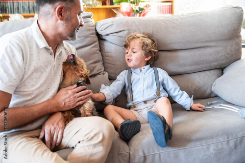 Father and son bonding with their playful pet dog at home photo