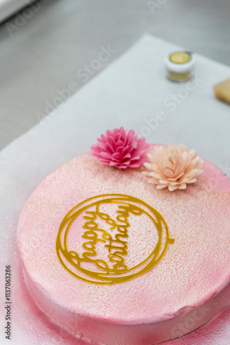 Elegant pastel birthday cake with floral decorations photo