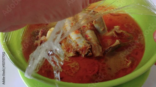 Goat Curry or Gulai Kambing opened from some plastic wrap. Gulai Kambing is a traditional Indonesian goat curry soup, a rich and spicy type of food