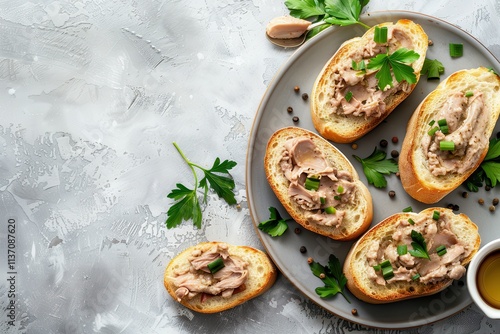 Chicken liver pate on baguette gray background top view