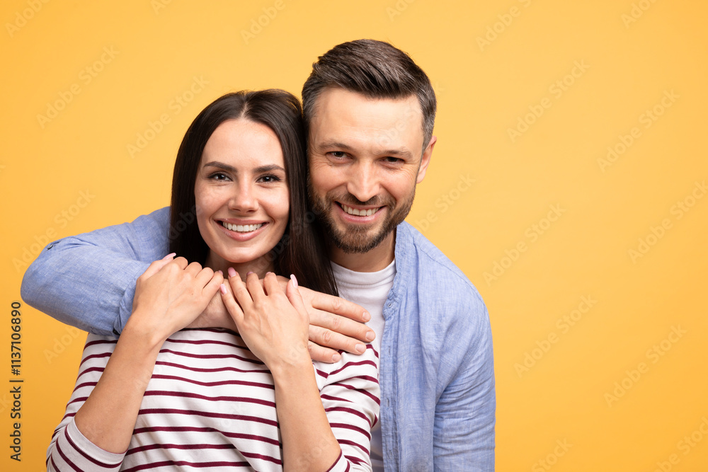 A married couple poses together with affection, showcasing their connection. They smile brightly while embracing, creating a friendly and warm atmosphere in a vibrant setting, copy space A married couple poses together with affection, showcasing their connection. They smile brightly while embracing, creating a friendly and warm atmosphere in a vibrant setting, copy space