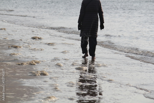 Image of people walking barefoot at Dadaepo Beach in Busan
