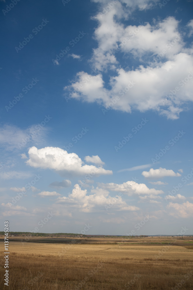 Blue sky with blue clouds over fields where the harvest has been collected. Blue sky with blue clouds over fields where the harvest has been collected.