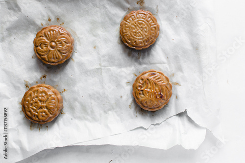 homemade mooncakes on a white background, top view of baked mooncakes on white table, process of making mooncakes for Lunar New Year and mid autumn festival photo