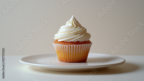 A cupcake with clean white frosting on a plai photo