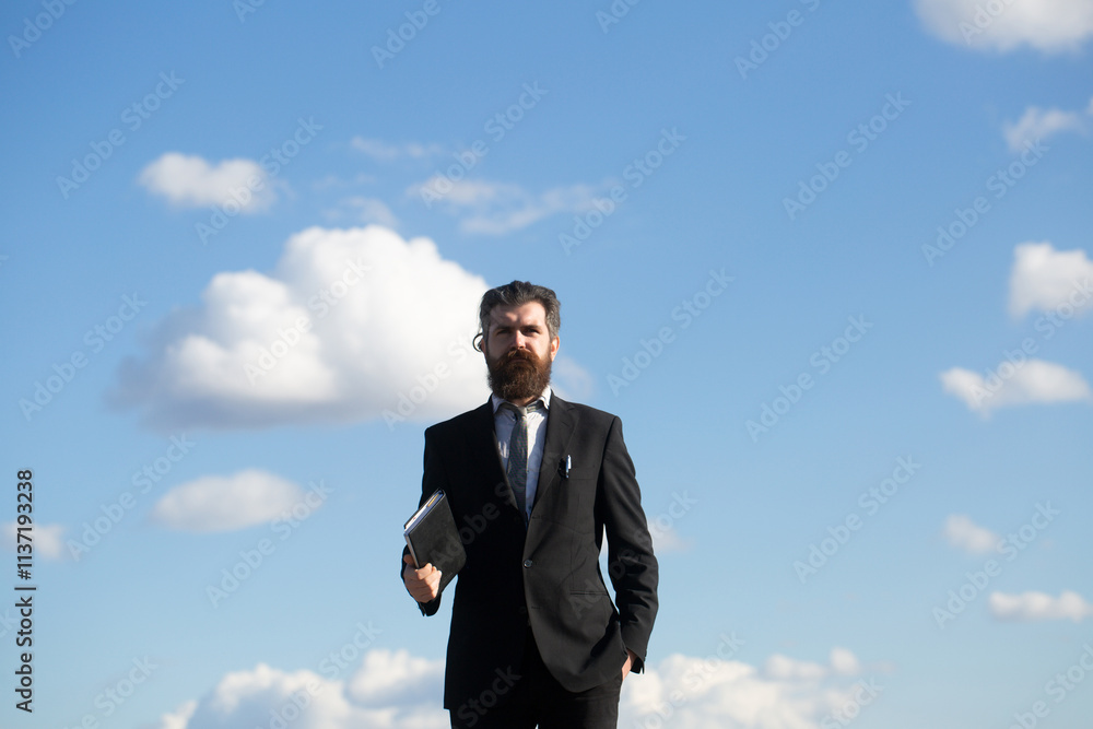 Business man on sky. Business man is thinking about something with pencil. Young thoughtful bearded man think. Business man on sky. Business man is thinking about something with pencil. Young thoughtful bearded man think.
