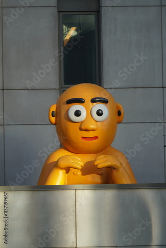 orange bald man statue