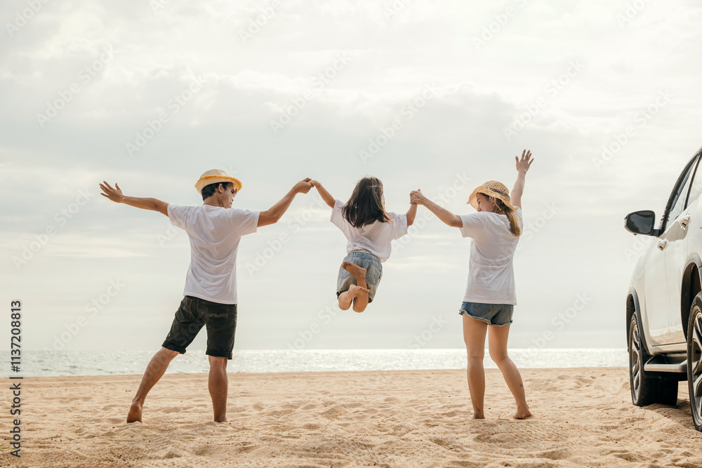 Happy family three hand in hand and jumping on sandy beach, Parents father and mother jump their children back car, holiday vacations summer road trip, Family day enjoying their time together Happy family three hand in hand and jumping on sandy beach, Parents father and mother jump their children back car, holiday vacations summer road trip, Family day enjoying their time together