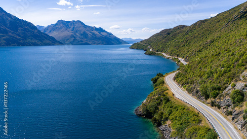 road to the mountains with view of a lake