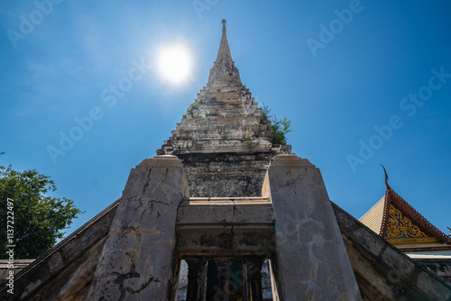 The old pagoda at Wat Klang Khlong Watthanaram, or Wat Muang, in Sena, Ayutthaya, is famed for its vibrant purple ordination hall and intricate decorations, making it a notable landmark in the area.