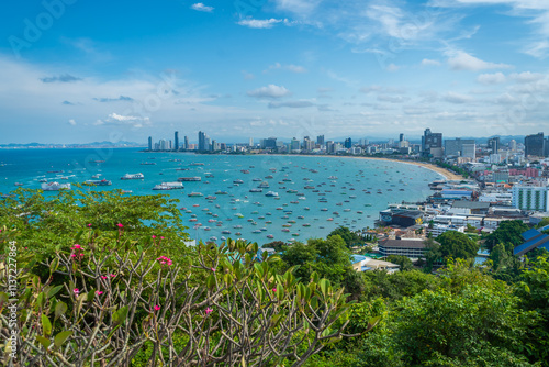 The Khao Phra Tamnak Viewpoint is a popular attraction in Pattaya, located on Phra Tamnak Hill. It offers stunning views of the city, the blue sea, blue sky, and numerous boats docked in Pattaya Bay