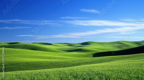 Lush green grassy hills under bright blue sky create serene landscape. rolling hills evoke sense of tranquility and natural beauty, perfect for outdoor enthusiasts