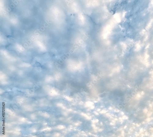 Beautiful sky with fluffy white clouds, soft and serene atmosphere, perfect for a clear and peaceful day