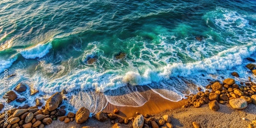 Top view of gentle sea waves crashing onto a rocky beach, sea, wave, beach, rock, ocean, water, nature, shore, coastline