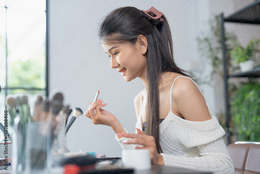 Asian woman applying make up foundation and concealer make up on face with cosmetics makeover Daily beauty routine at home. Asian woman applying make up foundation and concealer make up on face with cosmetics makeover Daily beauty routine at home.