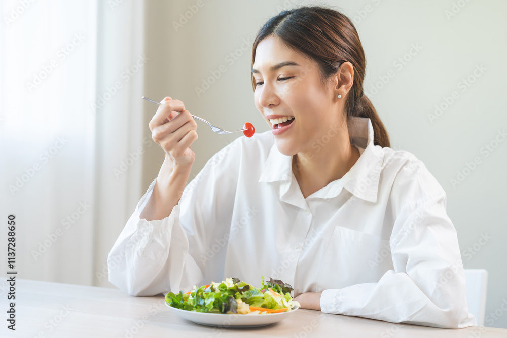 Diet concept, happy smile asian young woman use fork to prick tomato, fresh vegetable or green salad, eat nutrition food isolated on background, low fat to good body, getting weight loss for healthy. Diet concept, happy smile asian young woman use fork to prick tomato, fresh vegetable or green salad, eat nutrition food isolated on background, low fat to good body, getting weight loss for healthy.
