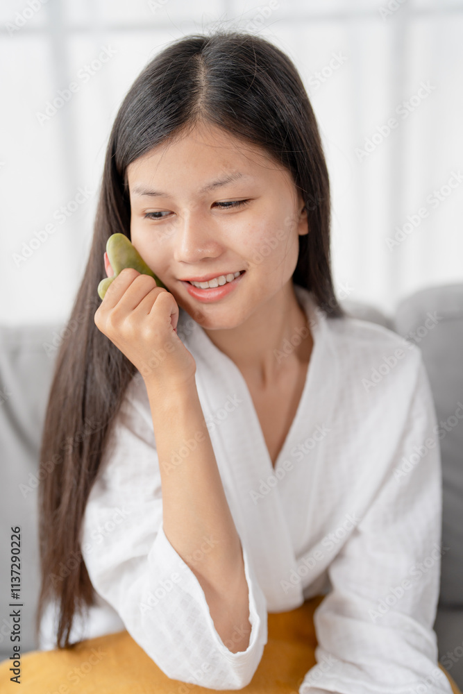 Daily beauty routine Asian woman self care doing gua sha facial massage Traditional medicine Gua Sha quartz stone Cosmetic natural trend. Daily beauty routine Asian woman self care doing gua sha facial massage Traditional medicine Gua Sha quartz stone Cosmetic natural trend.