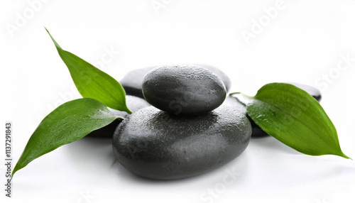 Spa stones and green leaves isolated on white