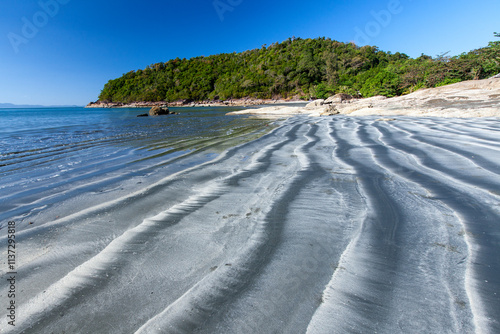 The black sand beach on a sunny summer.