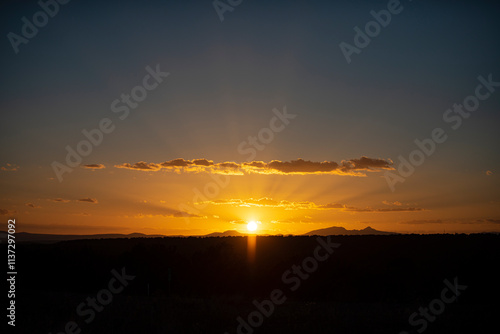 Sunset sky dramatic sunset clouds and sunset sunrays. Dramatic sky with clouds at sunset or sunrise. Sunrays. Skyscape nature composition. Natural sky background. Panorama scenic of the sunrise.