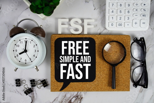 FSF - Free Simple and Fast acronym with calculator, alarm clock and magnifying glass, Business and Financial concept background photo