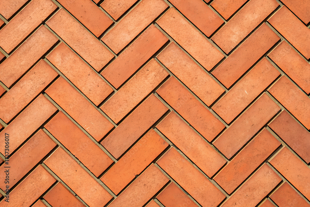 a pattern of rectangular, terracotta-colored bricks arranged in a staggered a pattern of rectangular, terracotta-colored bricks arranged in a staggered