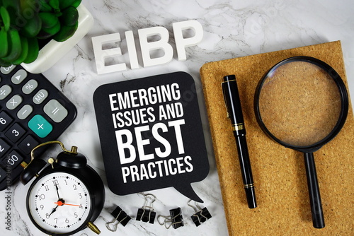 EIBP - Emerging Issues and Best Practices acronym with calculator, alarm clock and magnifying glass, Business concept background photo