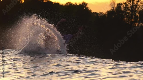 Male surfer on a wave at sunset time at Indian Ocean