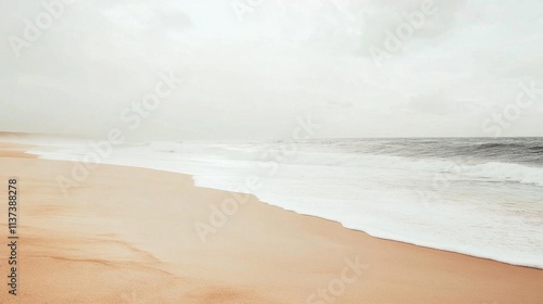 Serene beach scene with gentle waves and soft sand under a cloudy sky.