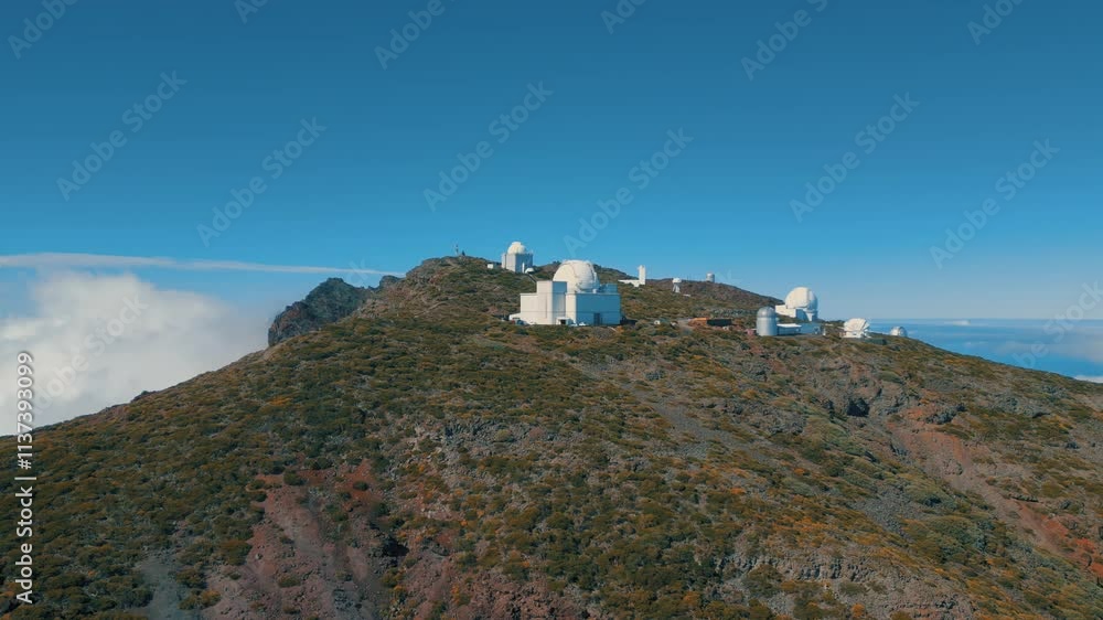 A breathtaking view of the Roque de los Muchachos Observatory, located atop La Palma, featuring panoramic scenes of clouds near the Caldera de Taburiente National Park. A breathtaking view of the Roque de los Muchachos Observatory, located atop La Palma, featuring panoramic scenes of clouds near the Caldera de Taburiente National Park.