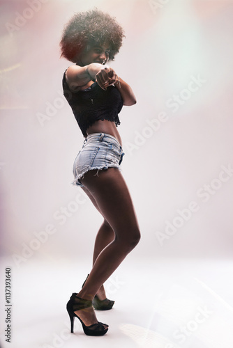 Young dancer pointing and smiling at the camera photo