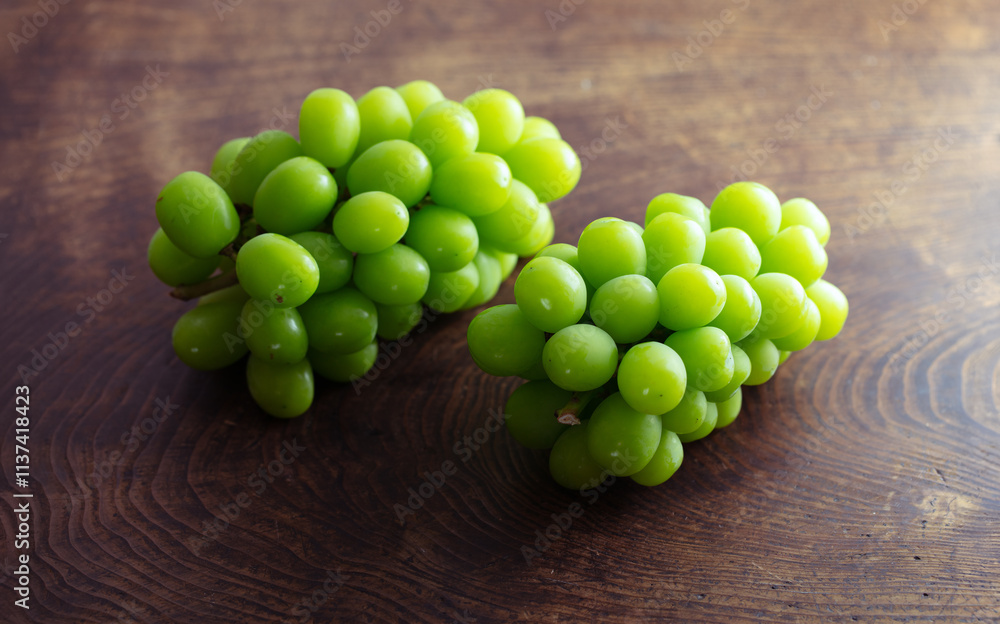 white (green) grapes on a wooden table. Grape Clusters from autumn Vineyard. Organic, Ripe, and Ready .Harvest season. white (green) grapes on a wooden table. Grape Clusters from autumn Vineyard. Organic, Ripe, and Ready .Harvest season.