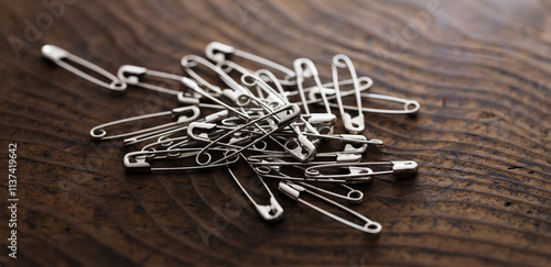 Safety pins on or a pin on a rustic wooden table. photo