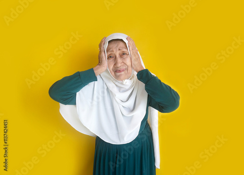 Elderly Asian Woman Holding Head Suffers From Headache Or Migraine