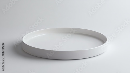 Empty white ceramic round tray on a white background.