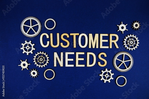 Customer Needs alphabet letters with gears element on navy blue background photo