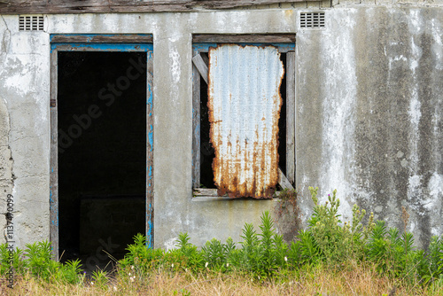 Detail of old derelic building showing rough, worn concrete and  paint photo