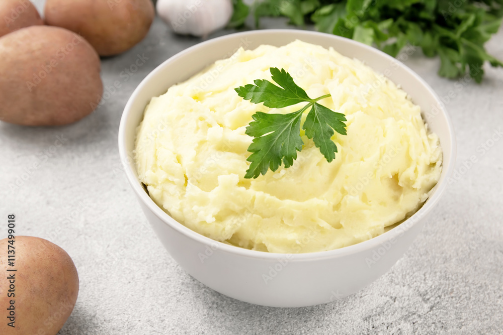 Mashed potatoes in white bowl on grey concrete background. Healthy food Mashed potatoes in white bowl on grey concrete background. Healthy food