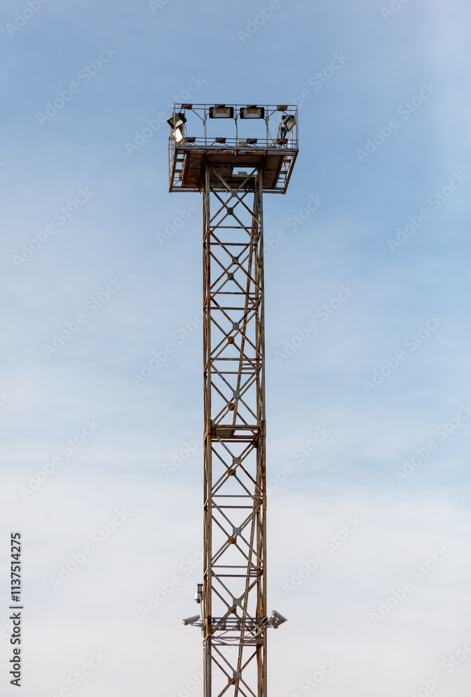 A tall metal structure with lights on top A tall metal structure with lights on top