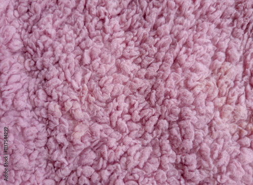 pink knitted fabric Wool surface blanket carpet photographed in close-up in pink color feel the material texture