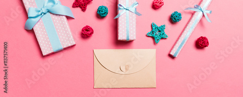 Top view of envelope on pink background. New Year decorations. Christmas holiday concept