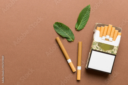 Pack of menthol cigarettes and fresh mint on colored table, Menthol cigarettes top view flat lay photo