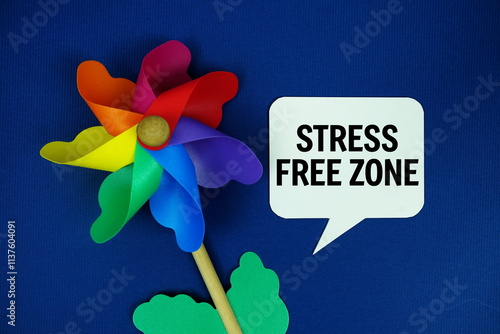 Stress Free Zone text  motivational and inspiration quote with colorful pinwheel top view on blue background photo