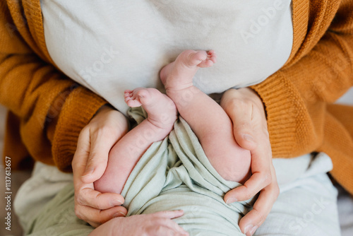 Newborn baby sleep first days of life at home. Young mother holding her new born child. photo