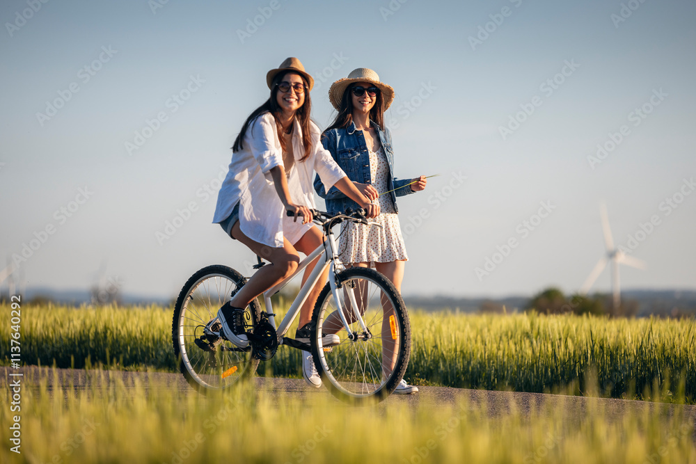 Young friends walking on road at field Young friends walking on road at field