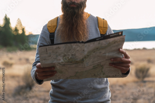 USA, North California, close-up of bearded man reading map on a hiking trip near Lassen Volcanic National Park