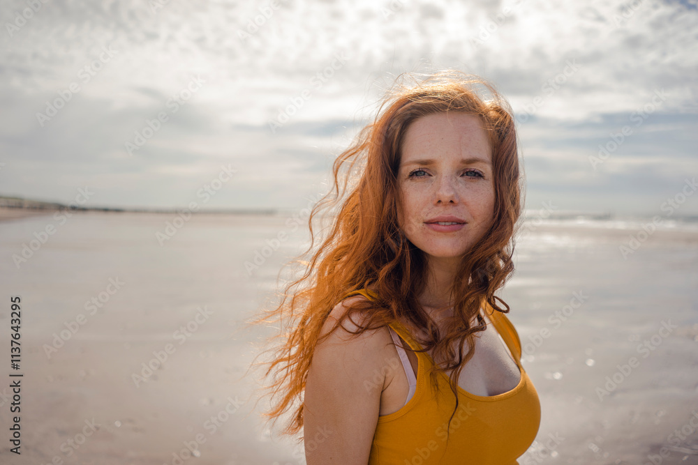 Netherlands, Zeeland, portrait of redheaded woman on the beach Netherlands, Zeeland, portrait of redheaded woman on the beach